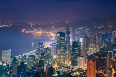 High angle view of illuminated city buildings at night