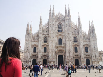 People walking in front of cathedral