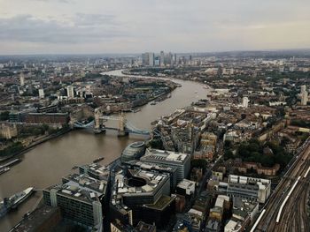 High angle view of city by river against sky