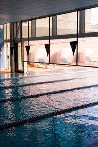 Swimming pool by sea against sky