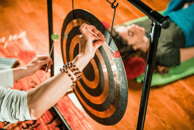 Therapist playing equipment while performing music therapy at spa