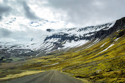 Scenic view of mountains against cloudy sky