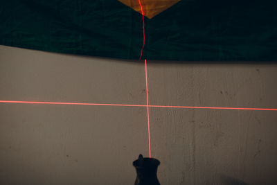 High angle view of person shadow on floor against wall