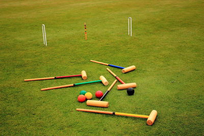 Croquet mallets and balls on field