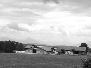 Houses on field against sky