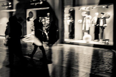 Blurred motion of women walking in city