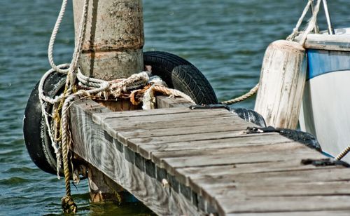 Close-up of boat on wooden post in lake