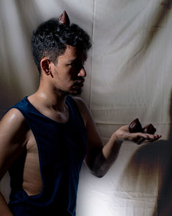 A yemeni indonesian mixed race man and three snake fruits