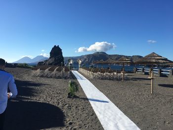 Scenic view of beach against blue sky