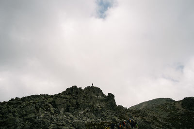 Low angle view of rocks on mountain against sky