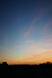 Silhouette of landscape against sky at sunset