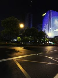 Illuminated city street at night