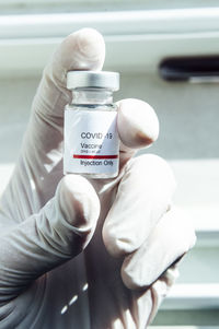 Doctor's hand showing covid-19 vaccine, new york