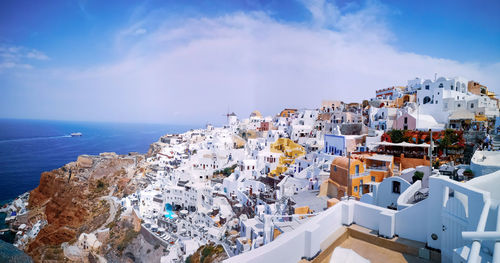 High angle view of townscape by sea against sky