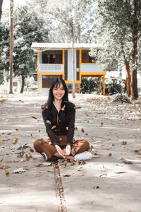 Portrait of a smiling young woman sitting outdoors