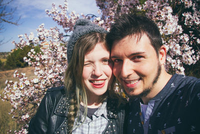 Portrait of smiling young couple standing at park