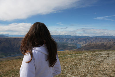 Rear view of woman looking at mountain landscape