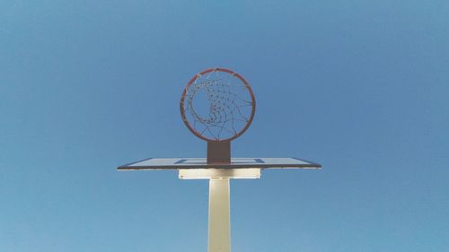 Low angle view of basketball hoop against blue sky