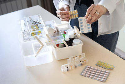 Cropped hand of doctor working on table