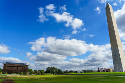 View of grassy field against cloudy sky