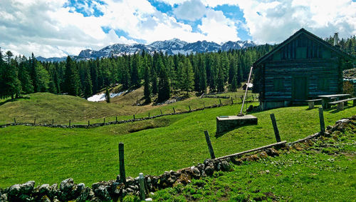 Scenic view of field and mountains against sky