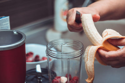 Cropped hands preparing food in kitchen