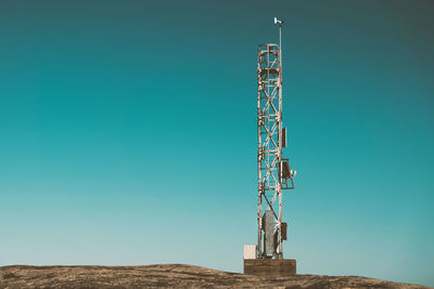 Communications tower against blue sky