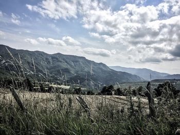 Scenic view of mountains against cloudy sky