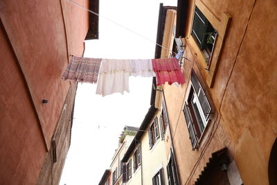 Low angle view of clothes drying against sky