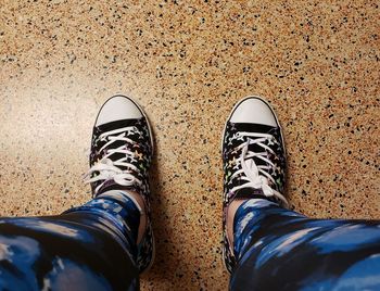 Low section of person wearing shoes standing outdoors