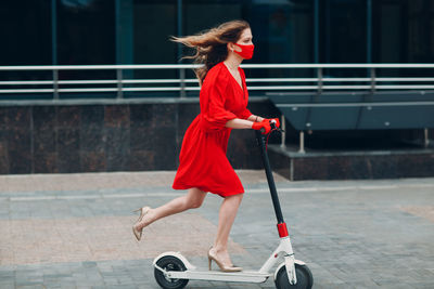 Full length of woman with red umbrella