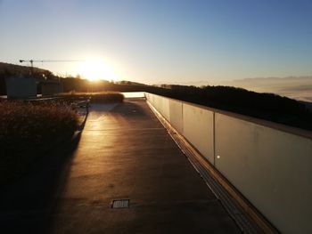 Bridge over river against sky during sunset