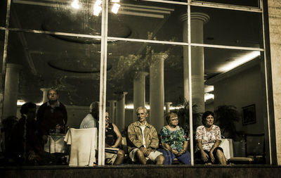 People sitting in illuminated room