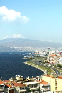 High angle view of buildings by sea against sky