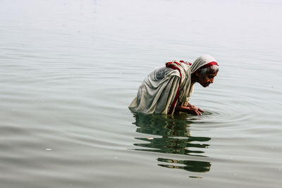 Reflection of man in lake
