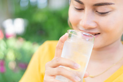 Close-up portrait of a woman drinking glass