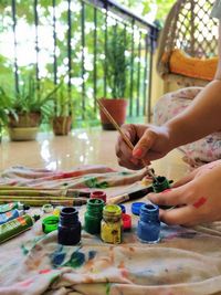 Midsection of girl painting at home