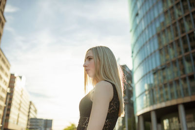 Young woman looking away in city