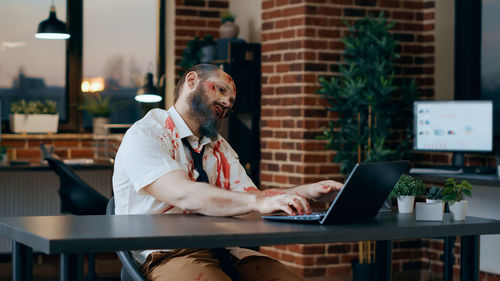 Young man using laptop at office