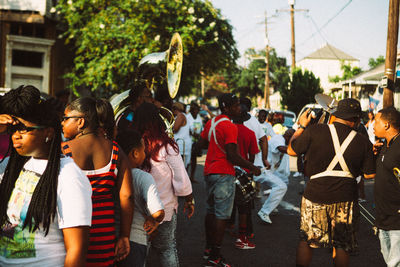 Group of people walking on street in city