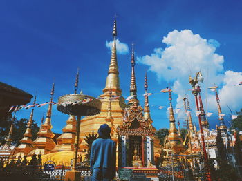 Low angle view of statue of buildings against sky