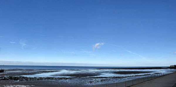 Scenic view of sea against blue sky