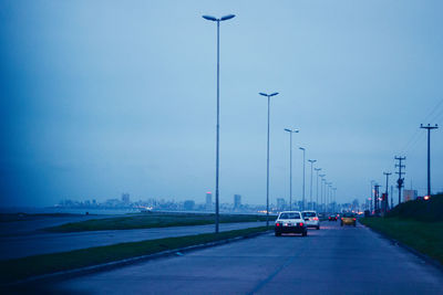 Cars on road against sky