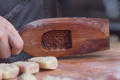 Close-up of person preparing food on table