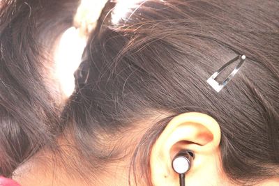 Cropped image of woman with in-ear headphones