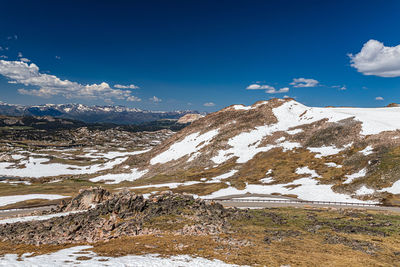 Scenic view of snowcapped mountains against blue sky