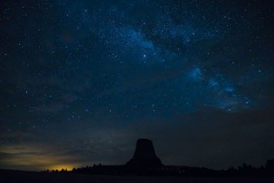 Low angle view of rock formation against sky at night