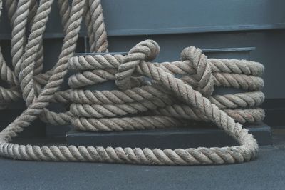 Close-up of ropes tied to metal on boat