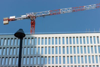 Low angle view of crane against clear sky