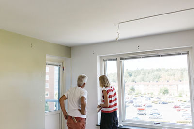 Couple standing in apartment